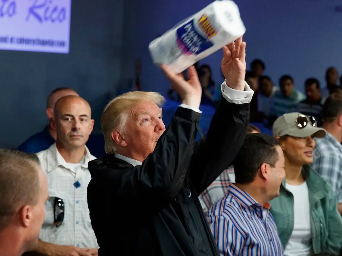 Donald Trump throwing papers towels at a press event in Puerto Rico after Hurricane Maria in 2017