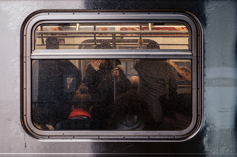 Looking through a crowded subway car window